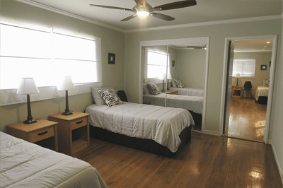 Bright resident room with twin beds and lamps