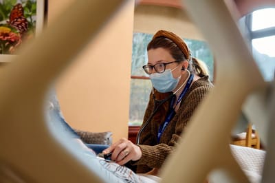 Nurse attending to a resident in a cozy room