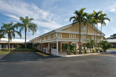 Exterior view of Darcy Hall with palm trees