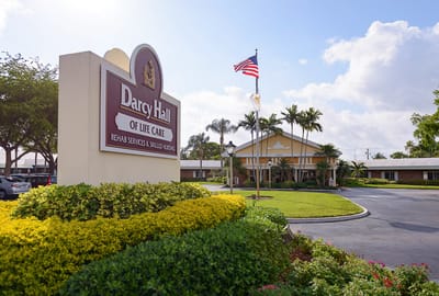 View of Darcy Hall exterior with sign and landscaping