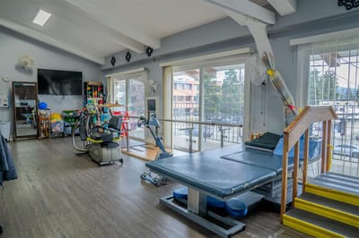 Rehabilitation area with therapy equipment and large windows