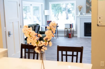 Bright common area with seating and fireplace