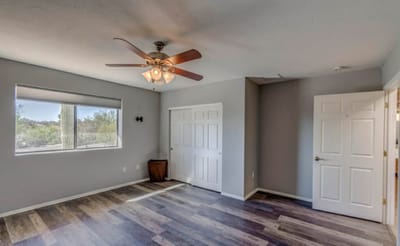 Bright interior room with window and ceiling fan