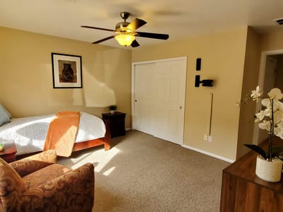Comfortable resident room with a bed and chair