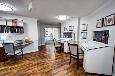 Interior view of a common area with desks and artwork