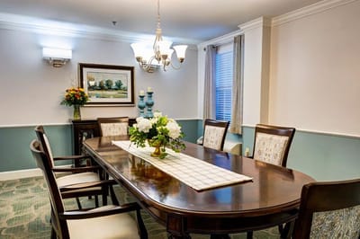 Elegant dining room with a wooden table and floral centerpiece