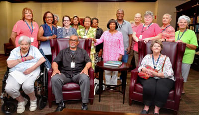 Residents and staff posing in a common area