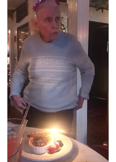 Resident celebrating with a birthday cake at the table