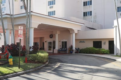 Entrance of a senior living facility with landscaping