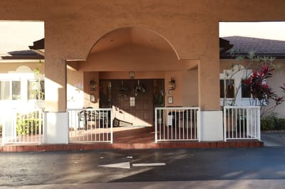 Front entrance of The Colony Club Sunrise with decorative plants