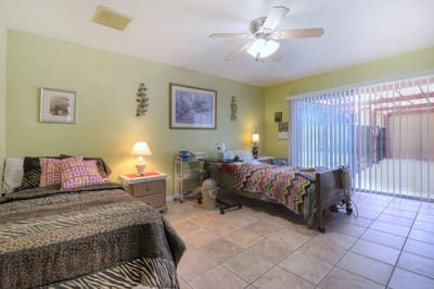 Private resident room with two beds and decorative accents