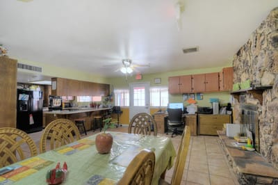 Common area with a dining table and kitchen space