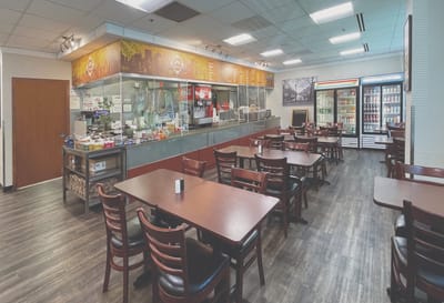 Dining area with tables and a serving counter