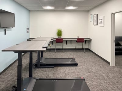 An interior fitness room with exercise equipment.