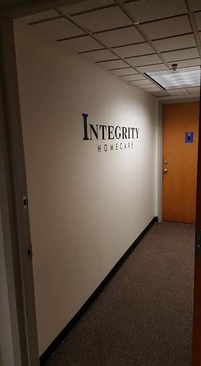 Interior hallway with signage for Integrity Home Care