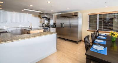 Interior kitchen and dining area with a table and appliances
