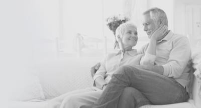 A couple enjoying each other's company on a sofa