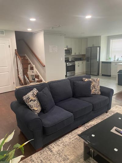 Cozy living room with a sofa and kitchen visibility