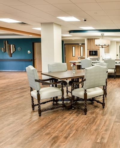 Bright common area with dining table and chairs