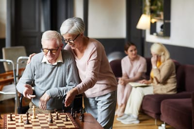 Residents enjoying a game of chess in a common area