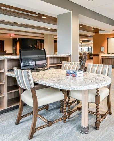 Interior common area with a table and computer setup