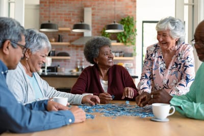 Residents enjoying a puzzle activity at a communal table