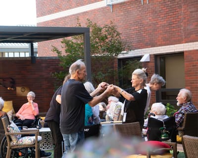 Residents and staff engaging in an outdoor activity