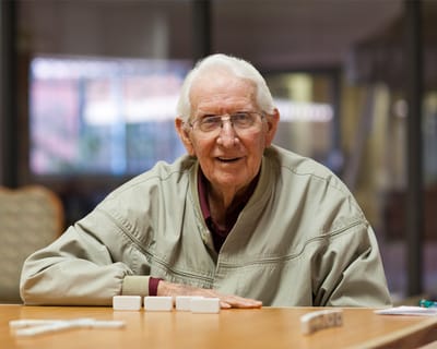 Smiling resident playing a game in a common area