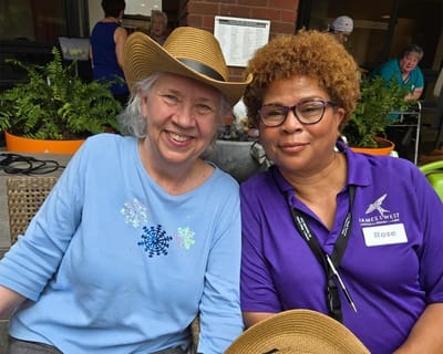 Two residents smiling at an outdoor event
