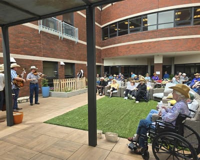Residents enjoying live music in an outdoor space