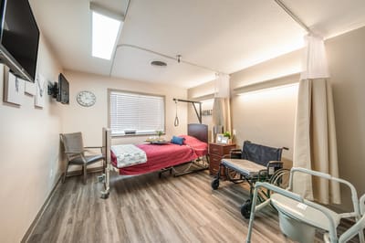 A private resident room with a bed and furniture