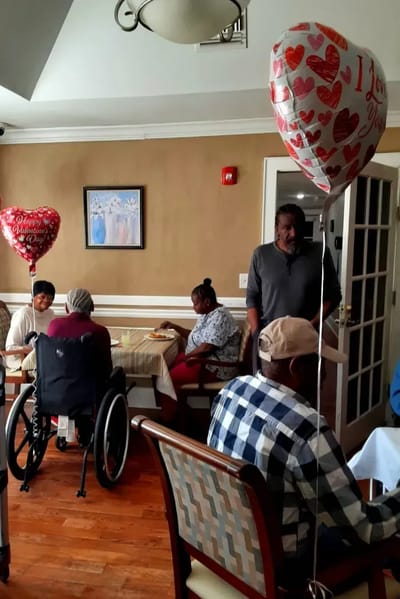 Residents enjoying a social gathering with balloons