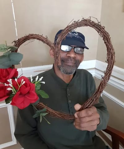 Resident holding a heart-shaped decoration with flowers