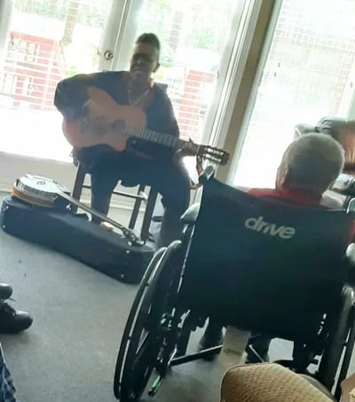 Resident enjoying a live music performance in a common area
