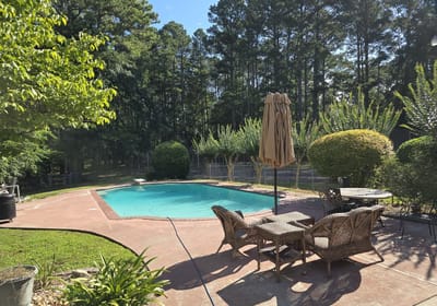 Outdoor space with a pool and seating area