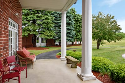 Outdoor patio area with seating and landscaping