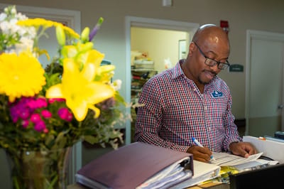 Staff member assisting at the reception desk