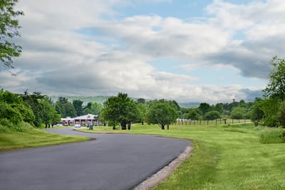 A view of the Life Care Center with green landscape