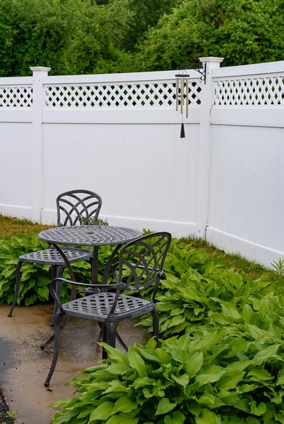 Two chairs and a table in a garden area