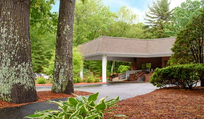 Entrance of the assisted living facility surrounded by trees