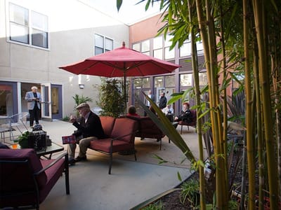 Residents enjoying a patio space with seating