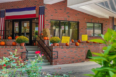 Entrance with fall decorations and flags