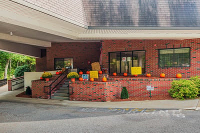 Entrance area adorned with pumpkins and flowers