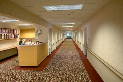 Interior hallway with staff at the reception desk