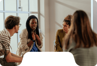 Group discussion with three individuals in a bright room