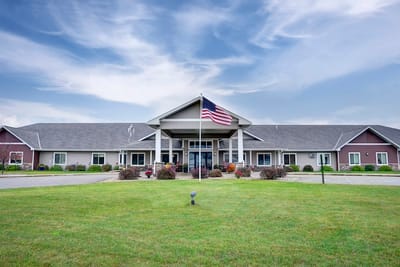 Exterior view of Legacy Care Home with American flag