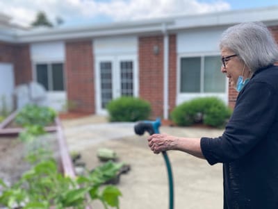 A resident gardening in an outdoor space