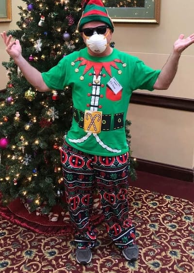 Resident dressed in festive holiday attire in the lobby