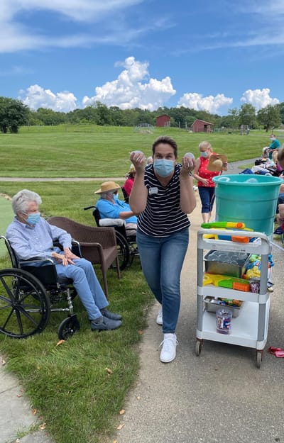Residents outdoors enjoying an activity with staff member