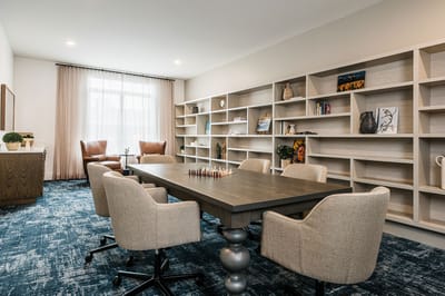 A cozy common area with a chess table and seating